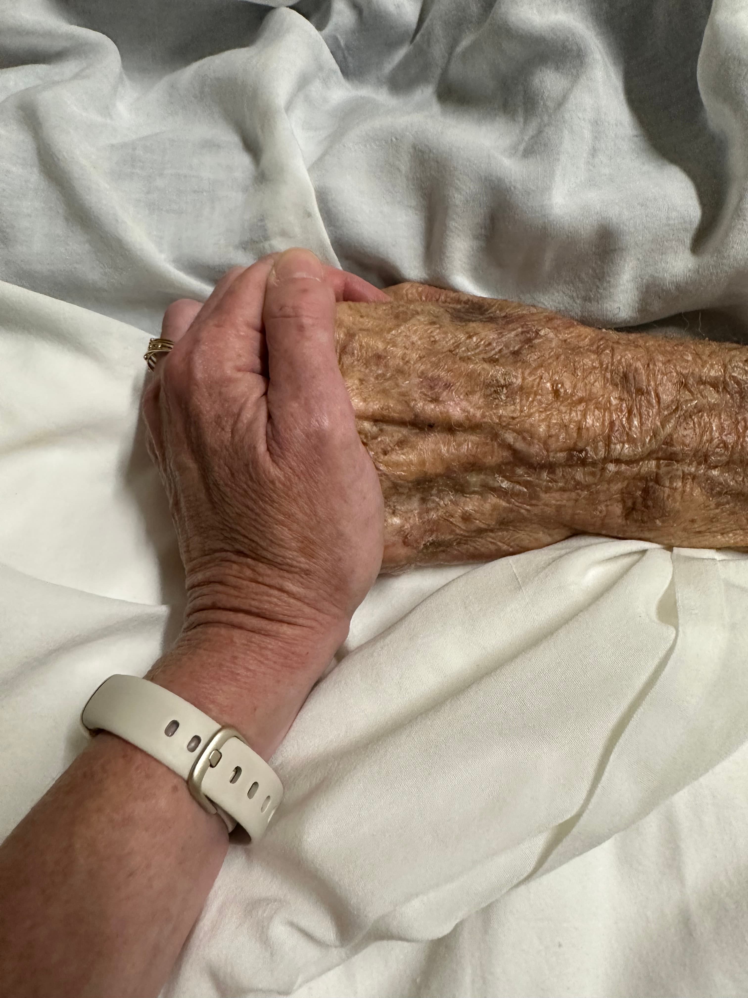 Hands resting together in a quiet room